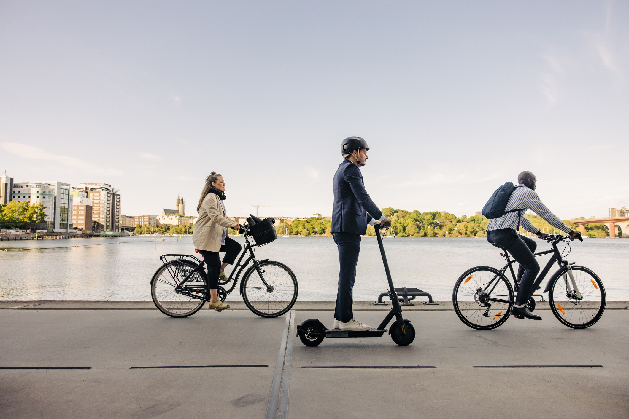 Fietsers en een man op step passeren de waterkant